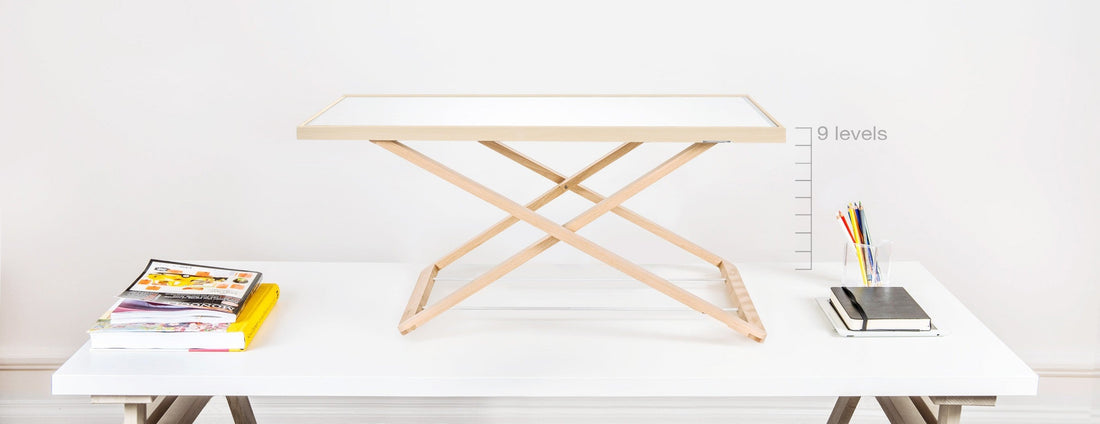 Desk riser in Scandinavian home office setup supporting sitting and standing work