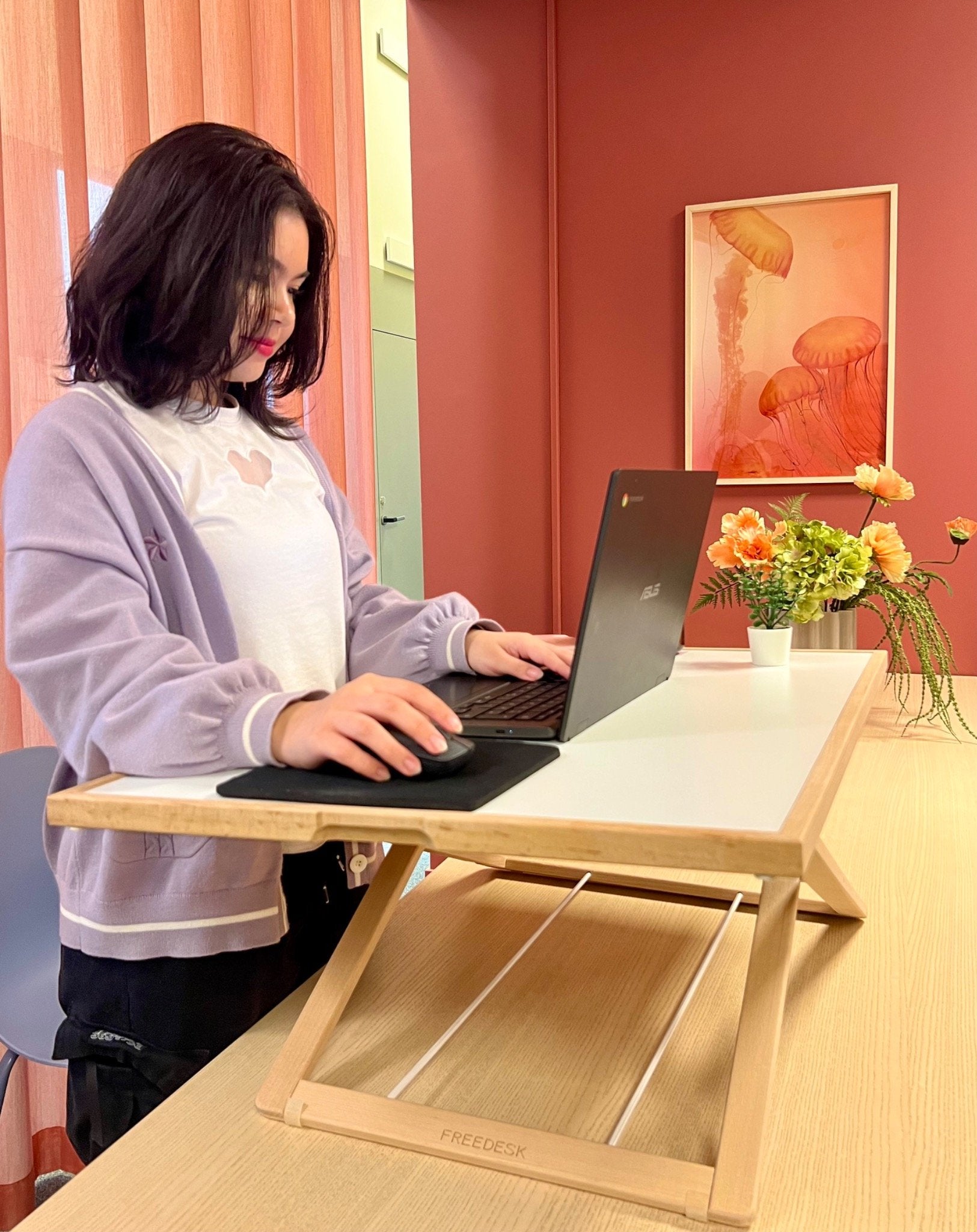 Freedesk Desk Riser Light Large on a dinner table.