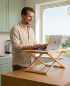 Person working while standing using a height & adjustable desk riser for better posture and flexibility