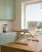 Ergonomic desk riser used at home to create a flexible and comfortable workspace setup