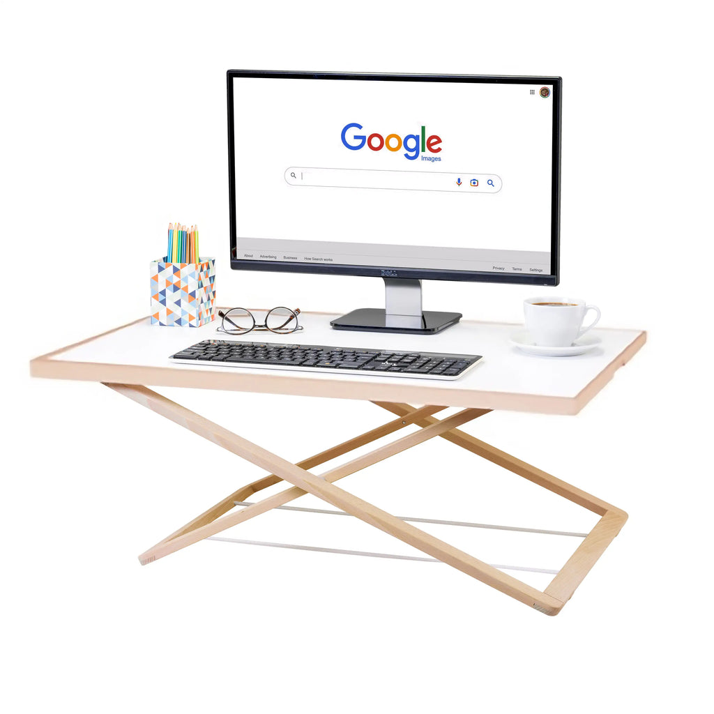 Freedesk Desk Riser Light Large in white, used as an ergonomic standing desk with a monitor, keyboard, and office accessories.