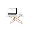 Freedesk Desk Riser Original Compact in white, used as an ergonomic standing desk with a laptop, glasses, and a coffee cup for a modern workspace.