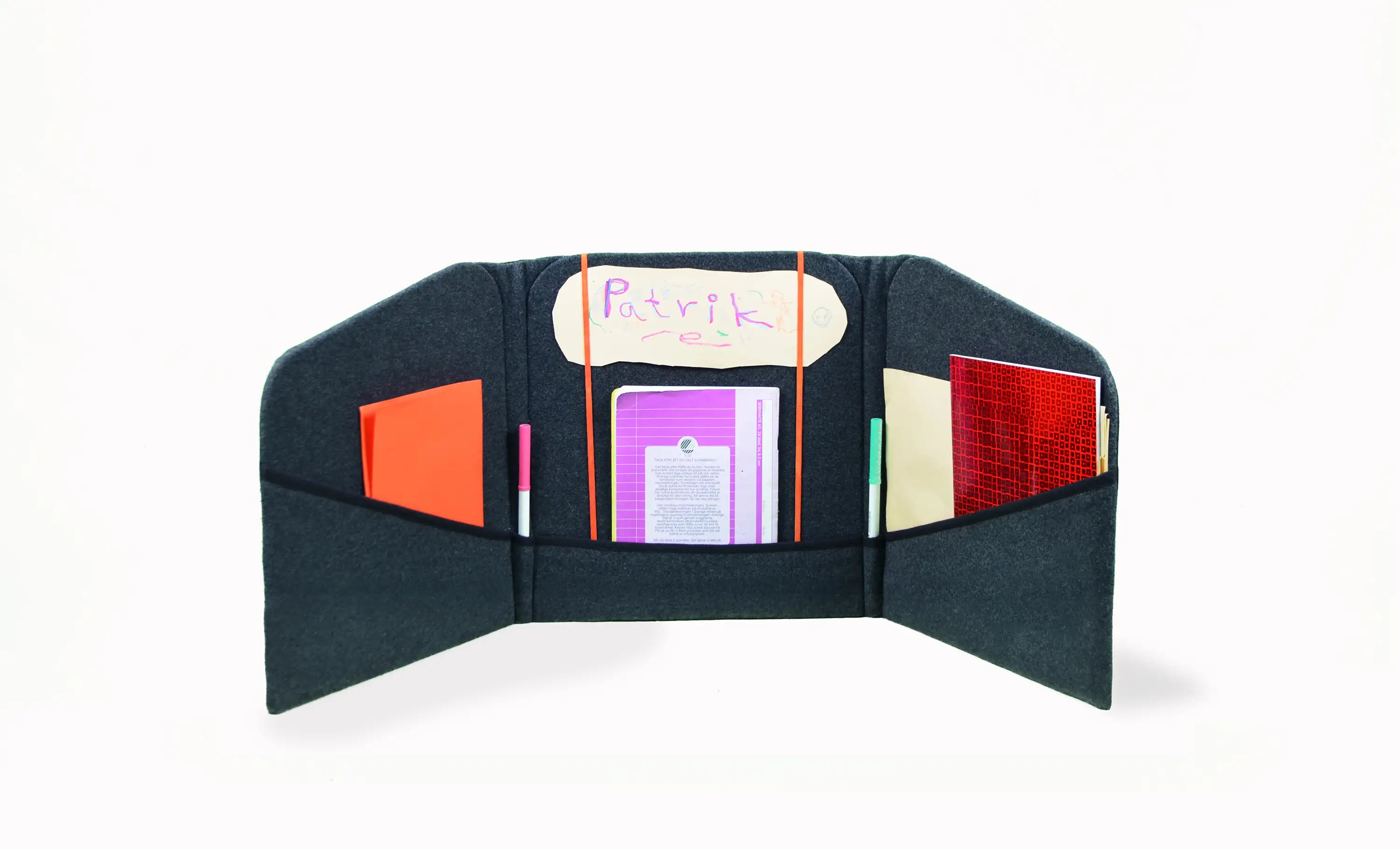 Freedesk Personal Space in black, used as an organized privacy screen with storage pockets for books, pens, and notes in a workspace.