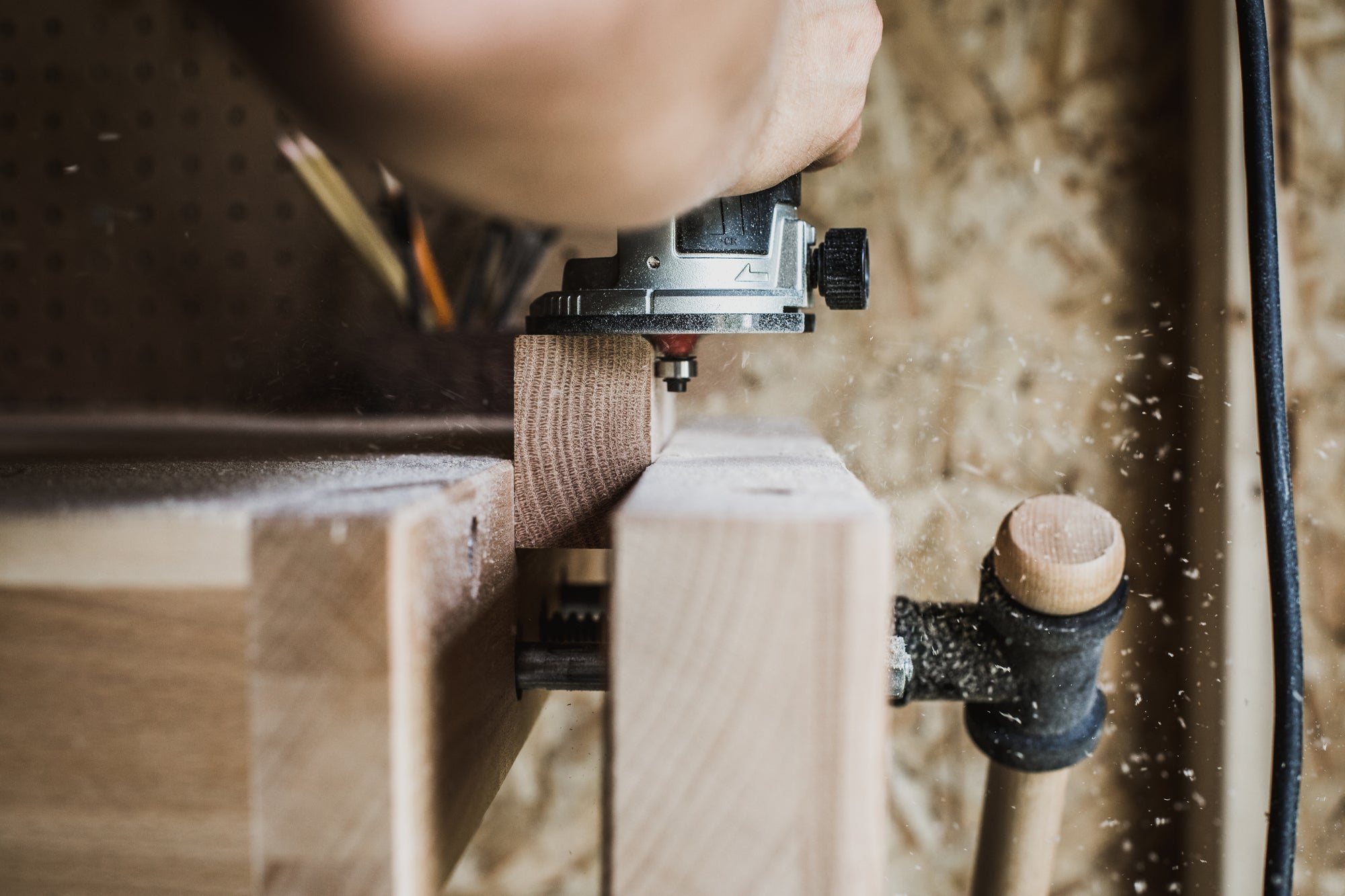 Close-up of woodworking craftsmanship, highlighting sustainable and high-quality production of Freedesk products.